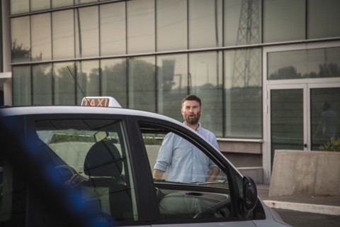 Caucasian man walking towards taxi