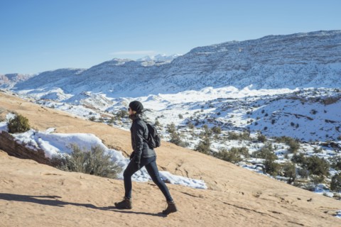 Caucasian woman hiking on remote hillside