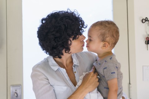 Caucasian mother kissing baby son
