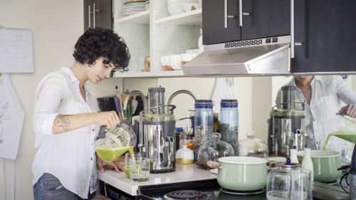 Caucasian woman pouring juice in kitchen
