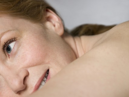 Close up of shoulder and face of nude Caucasian woman