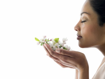 Woman smelling handful of flowers