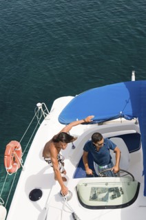 Men driving sailboat on ocean