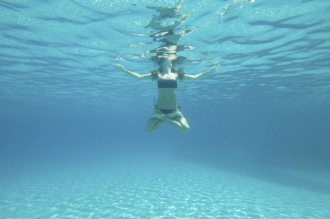 Underwater view of woman swimming in ocean