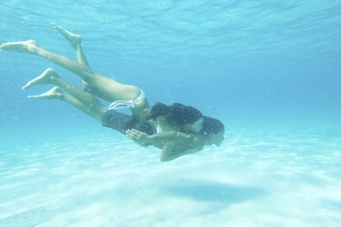 Underwater view of couple swimming in ocean