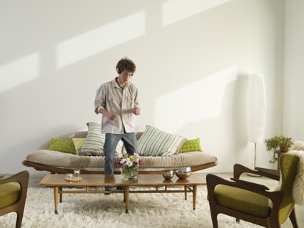 Mixed race man listening to headphones in living room