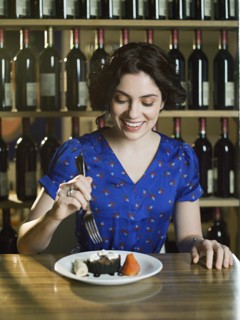 Caucasian woman eating dessert in restaurant