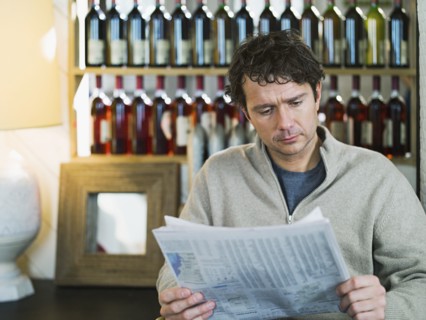Caucasian businessman reading newspaper in cafe