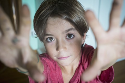 Caucasian boy reaching up