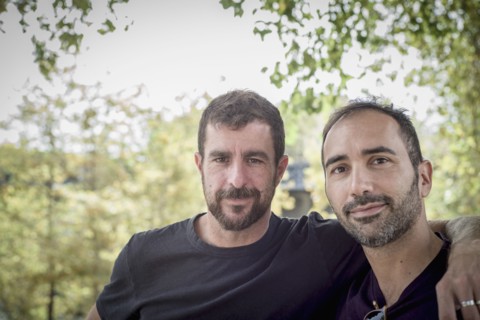 Caucasian gay couple hugging outdoors