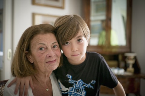 Caucasian grandmother and grandson hugging