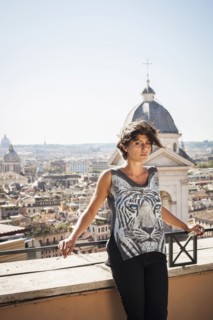 Caucasian woman standing on urban rooftop