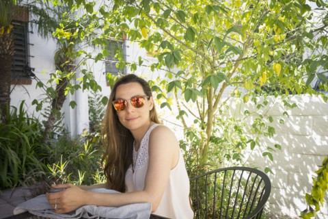 Caucasian woman sitting at table in garden