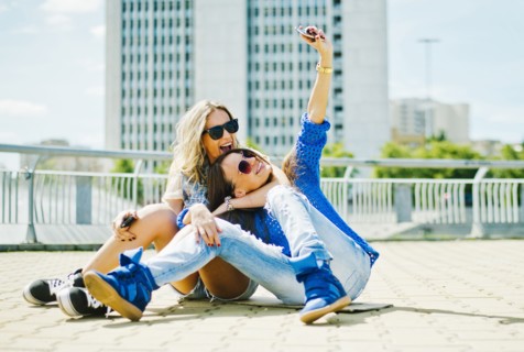 Women taking picture on city street