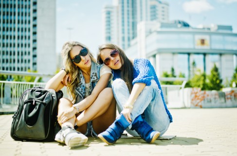 Women sitting on city street