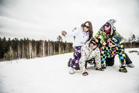 Caucasian friends smiling in snow