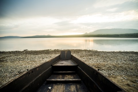 Dilapidated boat at rural lake
