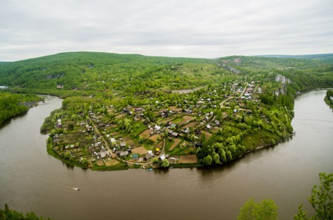Aerial view of village near bend in river