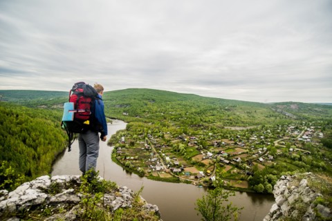 Caucasian hiker admiring scenic view of village