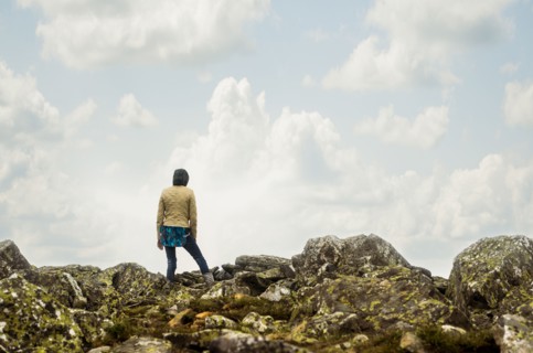 Caucasian hiker standing on rocky hilltop