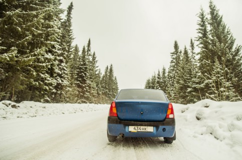Car driving on snowy remote road