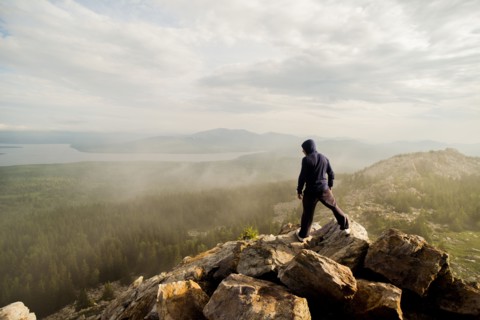 Caucasian hiker standing on rocky hilltop
