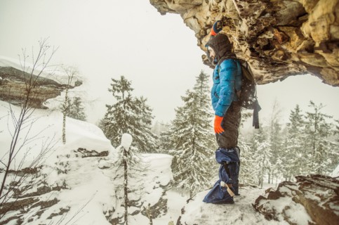 Caucasian hiker standing on snowy rock formations