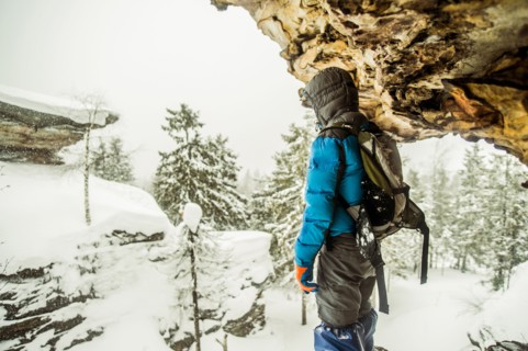 Caucasian hiker standing on snowy rock formations