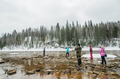 Caucasian hikers walking in rocky remote river