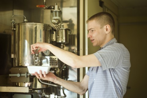 Caucasian man pouring hot water into bowl