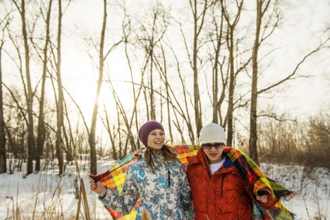 Caucasian couple wrapped in blanket outdoors