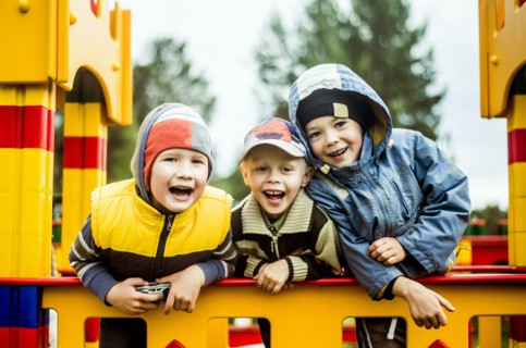 Caucasian boys smiling at playground