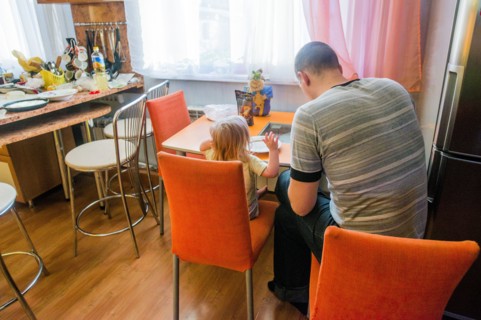Caucasian father and daughter sitting in kitchen