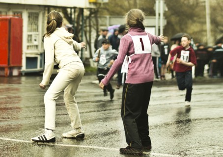 Caucasian children preparing for race on street