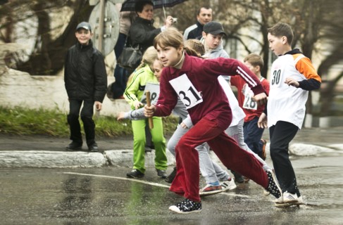 Caucasian children racing on street
