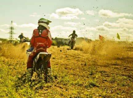 Caucasian motocross biker waiting on race course