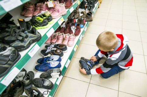 Caucasian boy shopping in shoe store