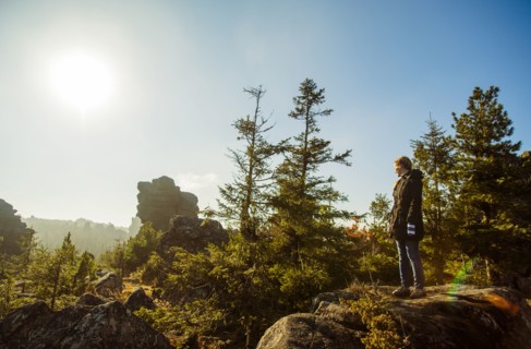 Caucasian hiker admiring view from remote hilltop
