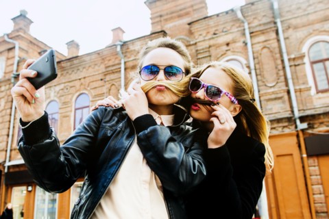 Women taking selfie in city