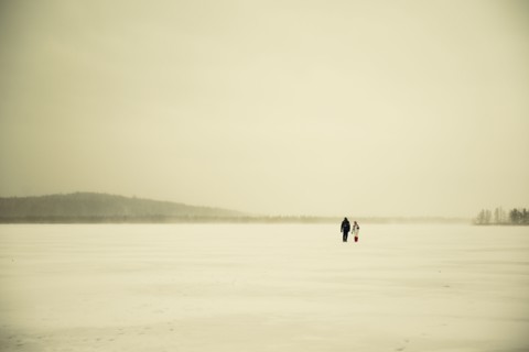 Caucasian hikers walking in snowy remote field