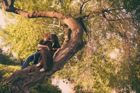 Caucasian couple kissing in tree
