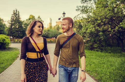 Caucasian couple holding hands in park