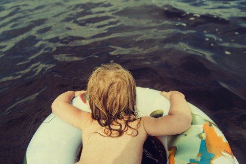 Caucasian girl swimming in lake