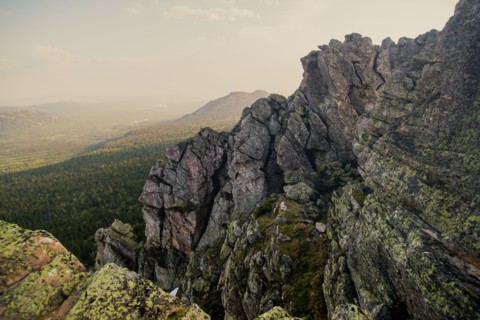 Rocky hillside over remote landscape