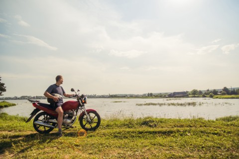 Caucasian man sitting on motorcycle in park
