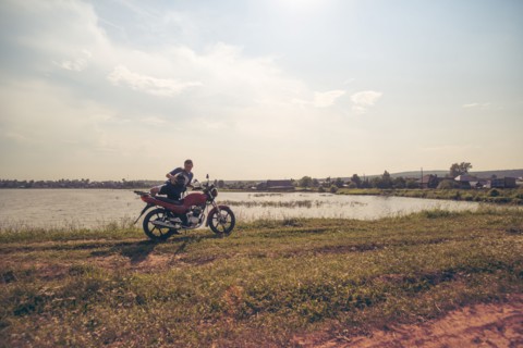 Caucasian man sitting on motorcycle in park