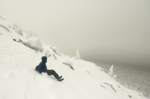 Caucasian man sledding on snowy mountain