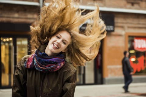 Caucasian woman tossing hair outdoors