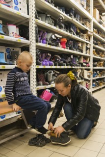 Caucasian mother and son shopping in store