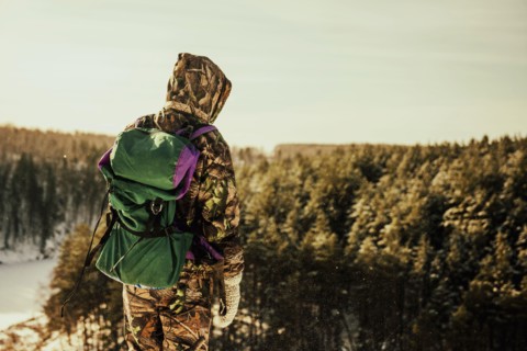 Caucasian hiker standing on hilltop